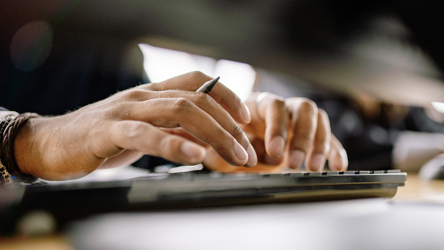 A close view of a person typing a laptop keyboard