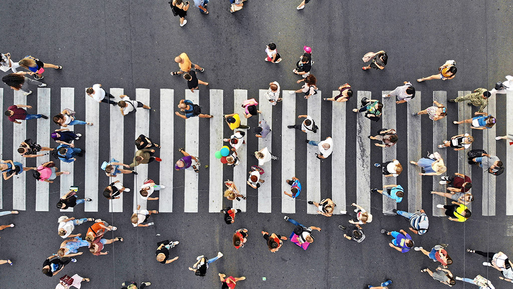 People crowd on pedestrian crosswalk