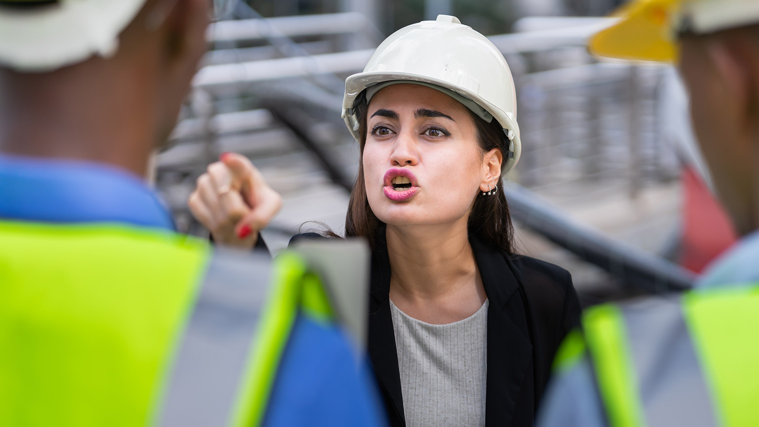 An angry person yelling at others on a construction site