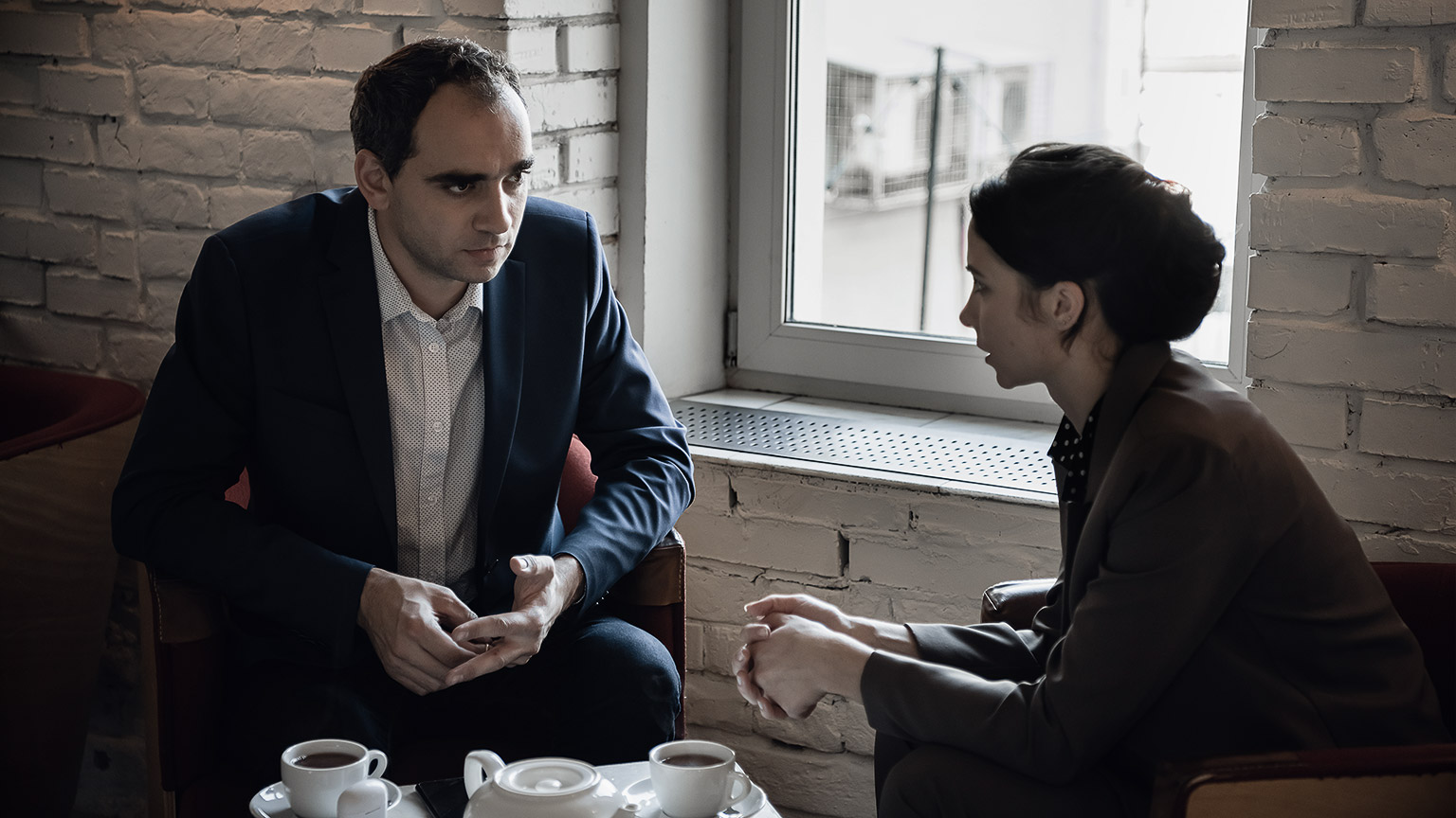 Businessman And Businesswoman Meeting In Coffee Shop