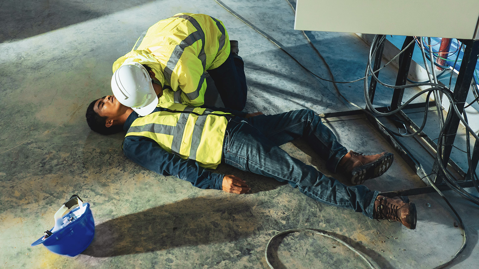 A person helping a coworker who is injured