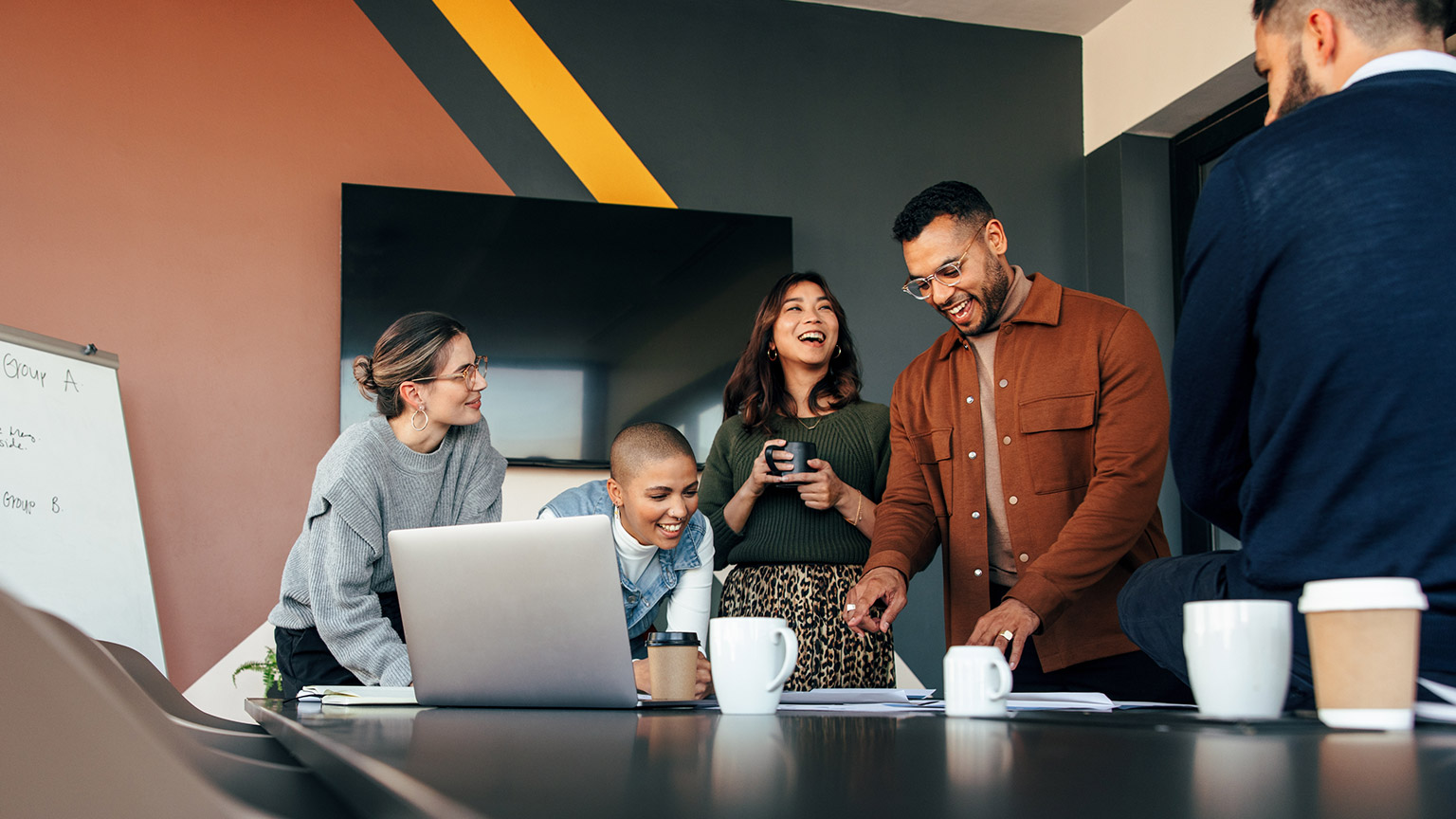 A group of hipsters discussing business in a modern office space