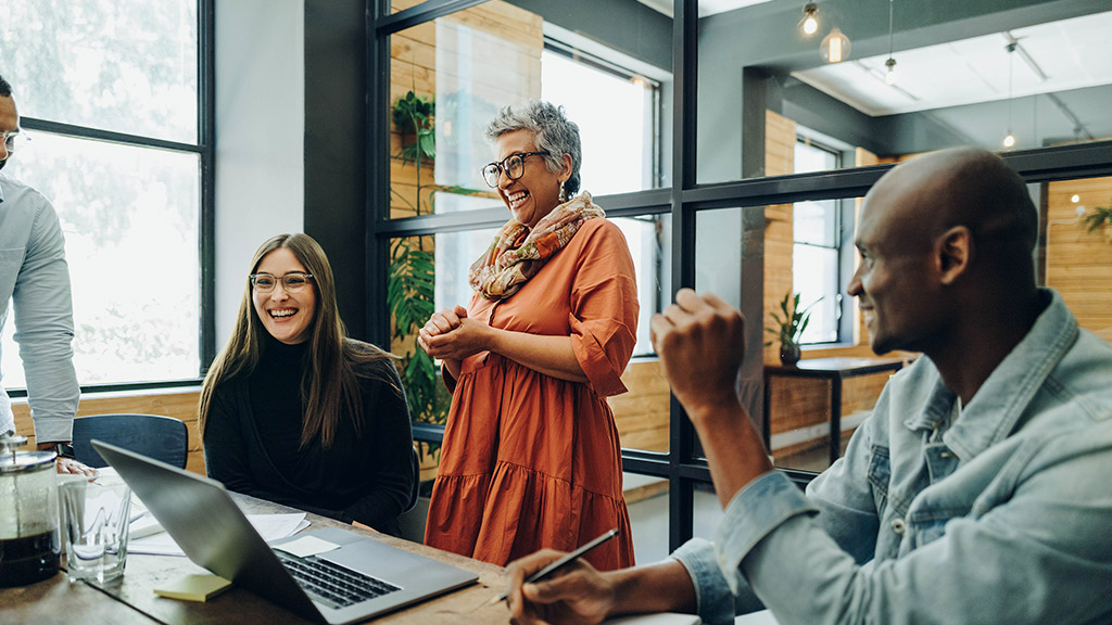 people smiling cheerfully during a meeting in a modern office