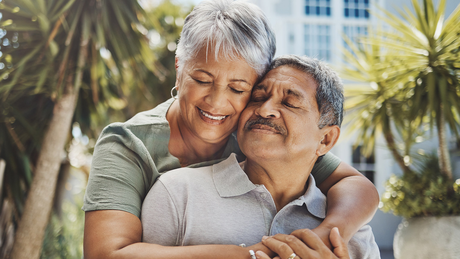 An elderly couple smiling and enjoying the outdoors