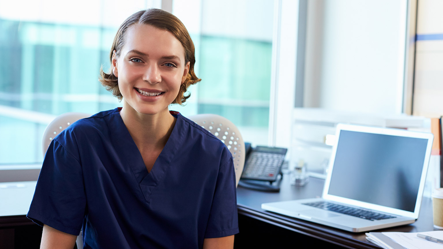 An aged care provider smiling at the camera