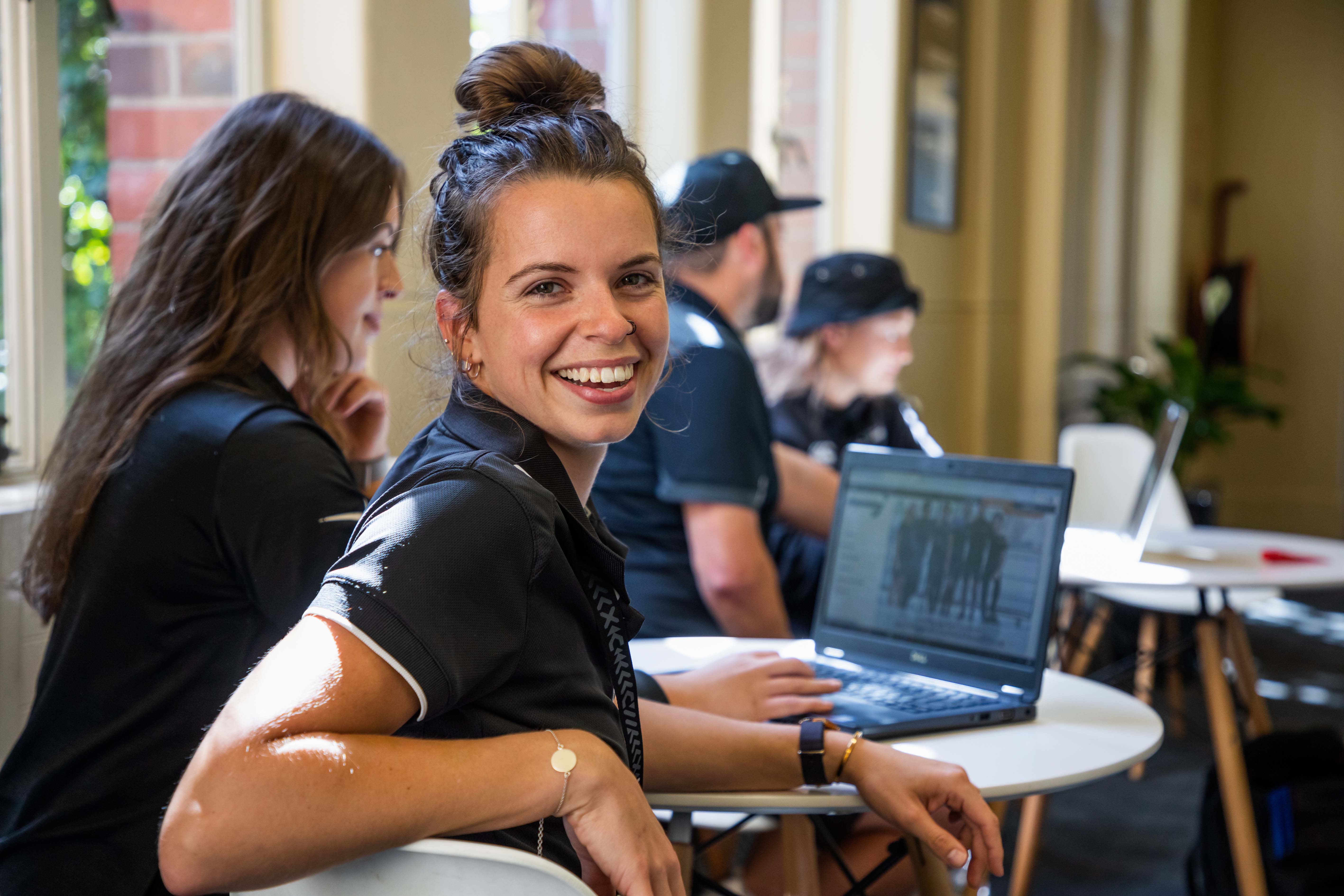 Happy students working on computer.