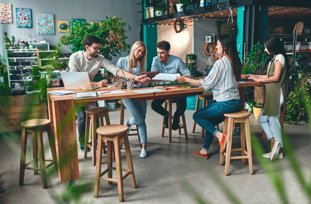 Group of young business people are working together on a company project in modern eco friendly office