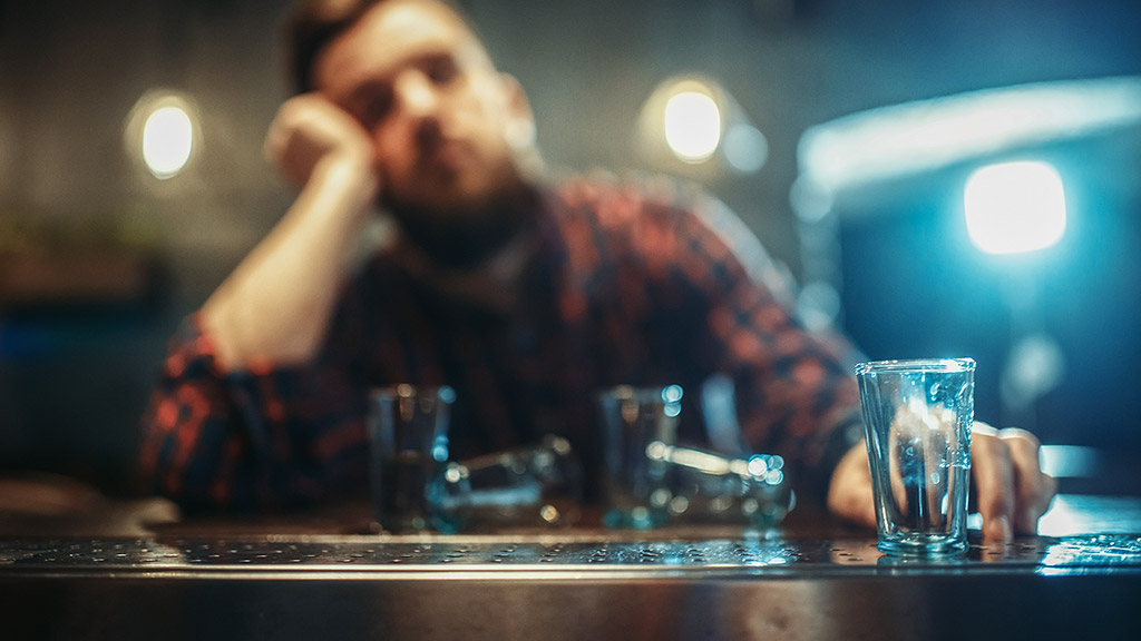 Drunk man at bar counter and dealing alcohol addiction