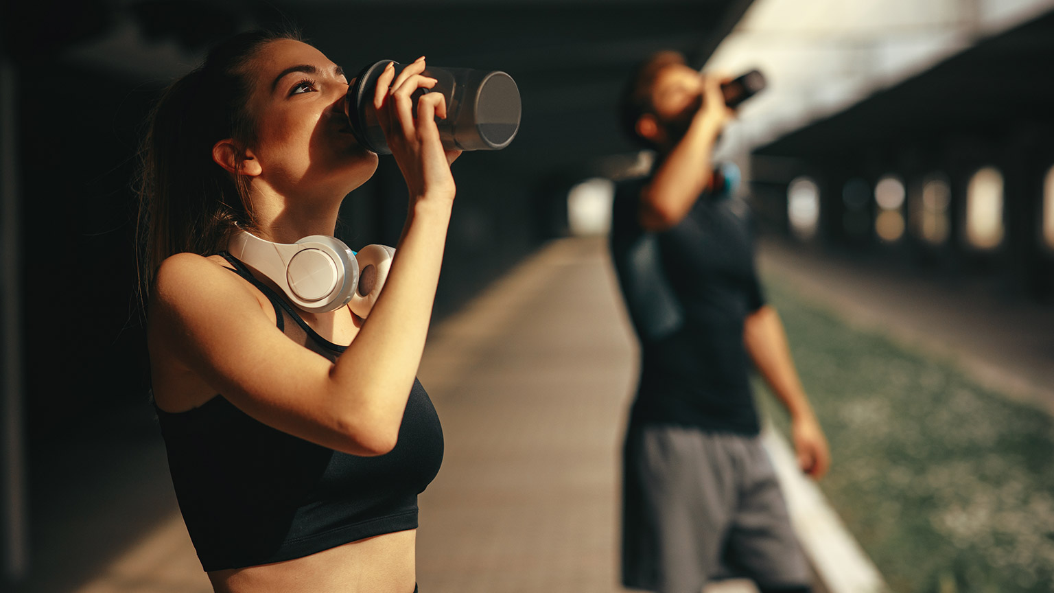 2 people rehydrating after exercise