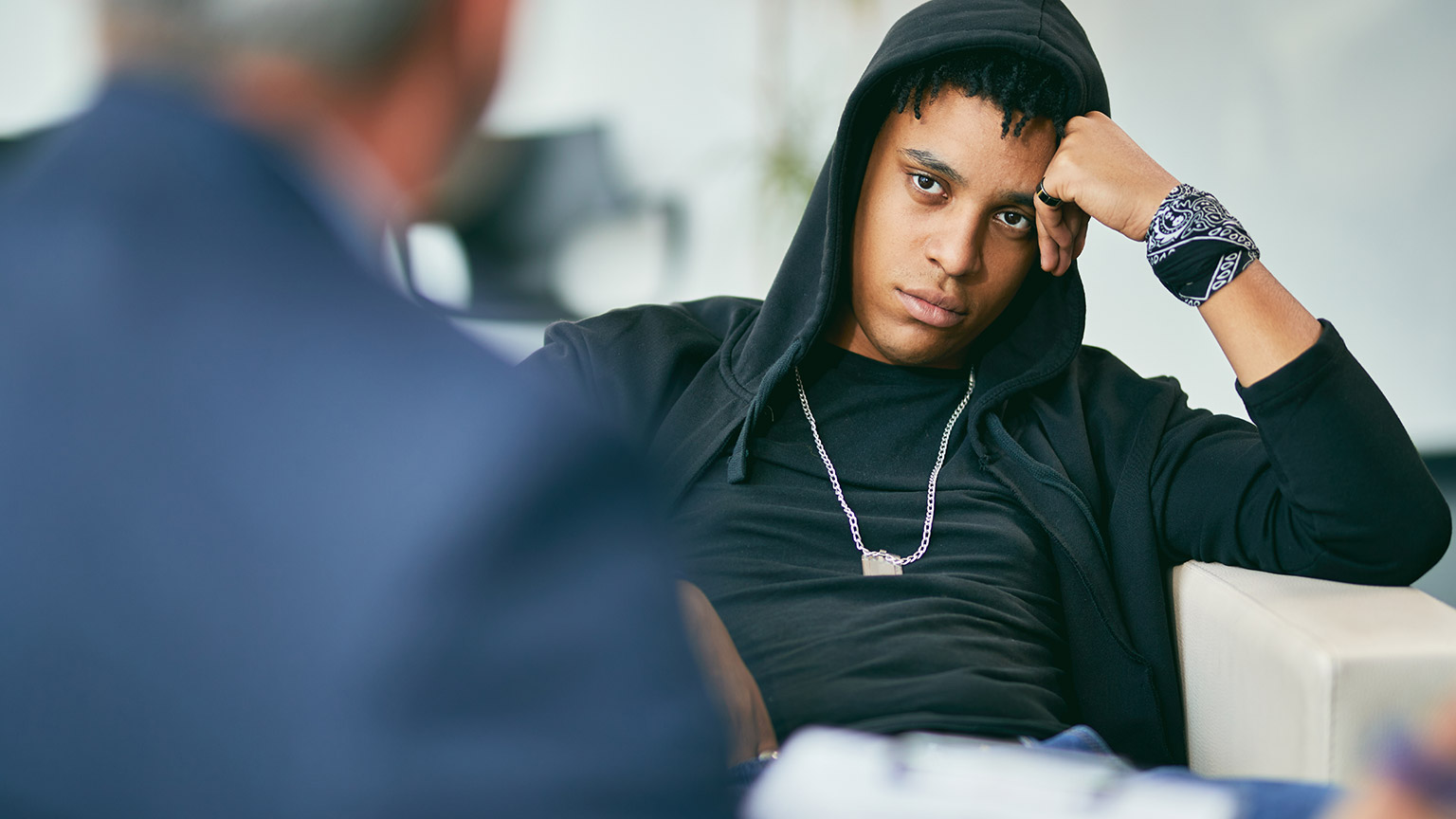 A surly teen talking to a counsellor