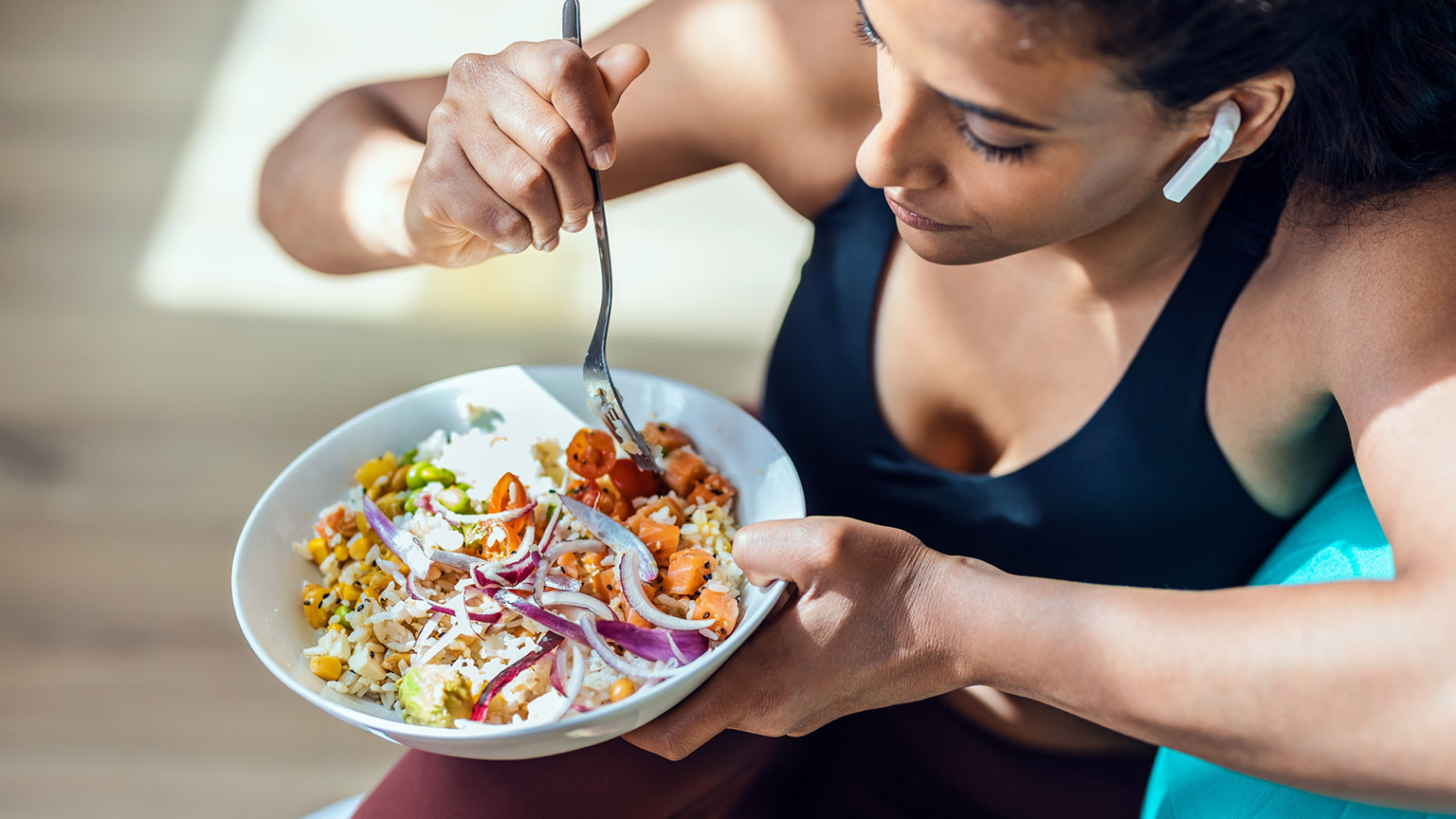 A person eating a healthy meal after exercise