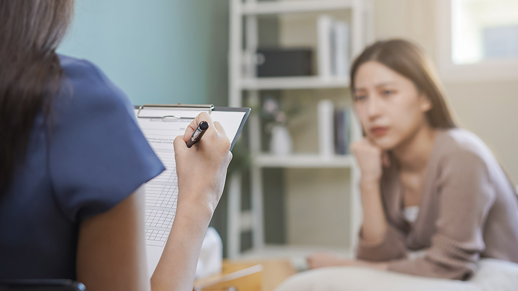 patient counseling mental with doctor woman taking notes at clinic