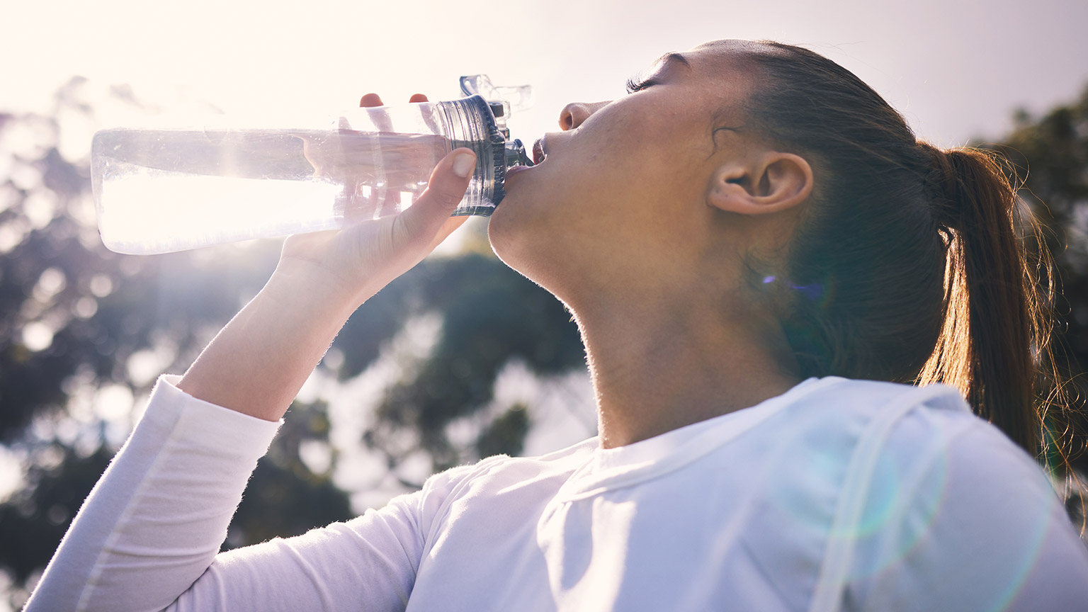 A person drinking water after exercise