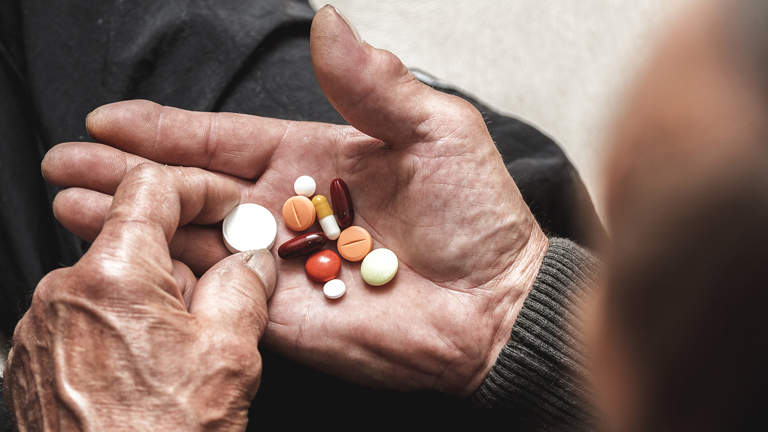 A close view of an elderly patient with lots of medication