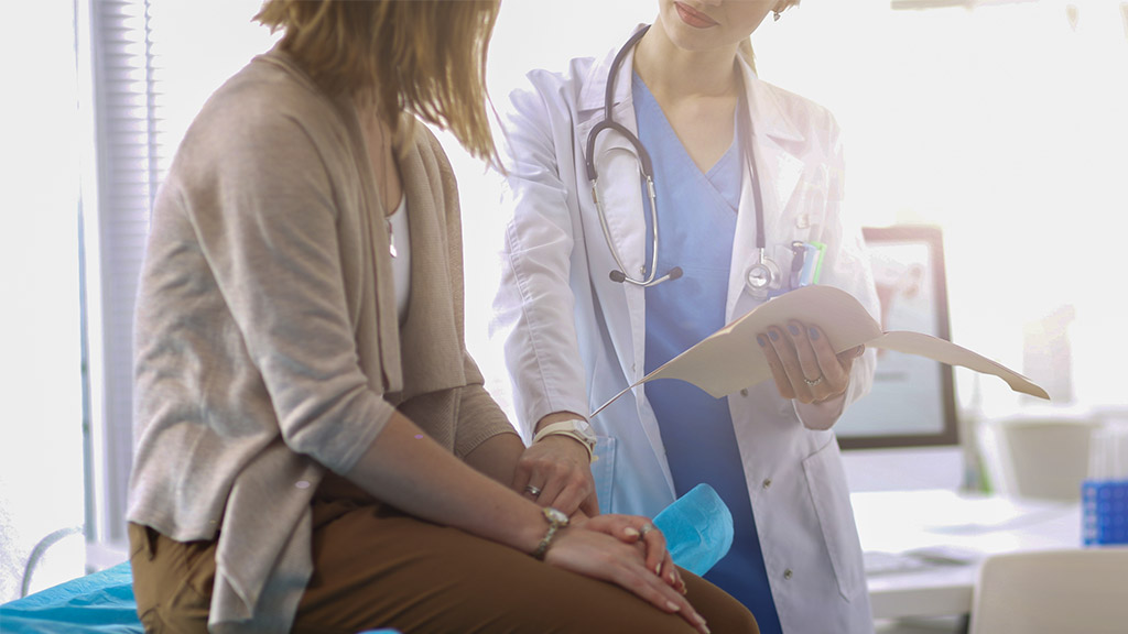 patient consulting a doctor while sitting at the table