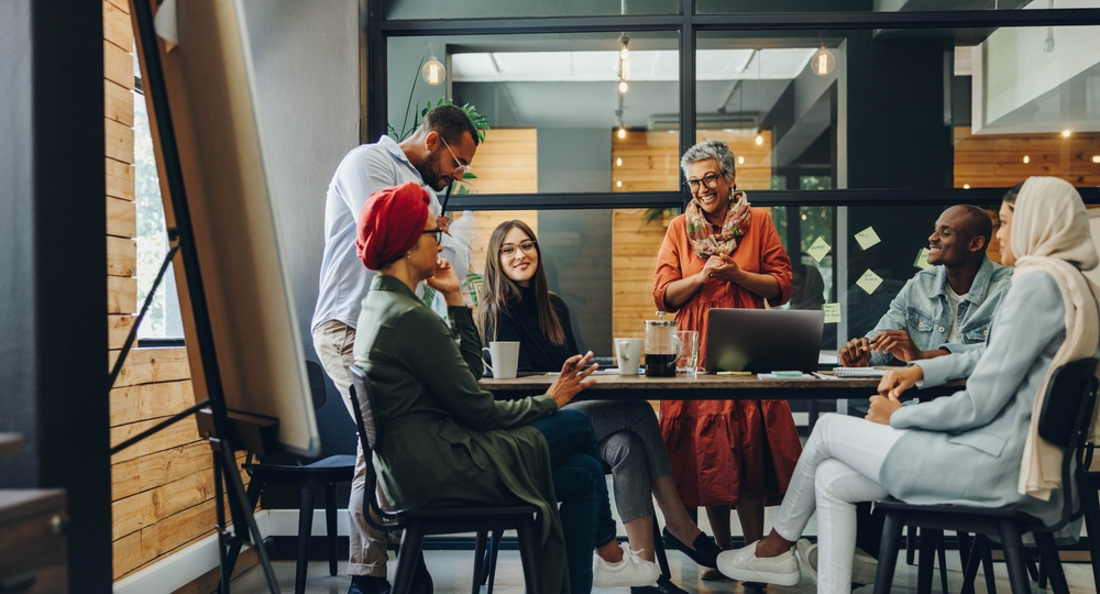 shutterstock_2164682885 Group of successful business professionals working as a team in a multicultural workplace.