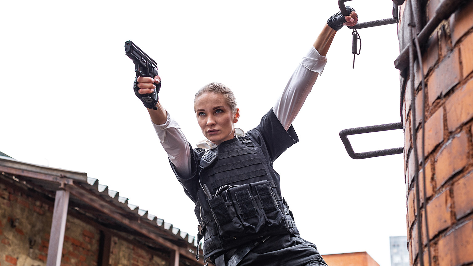 A person in an action movie with a gun