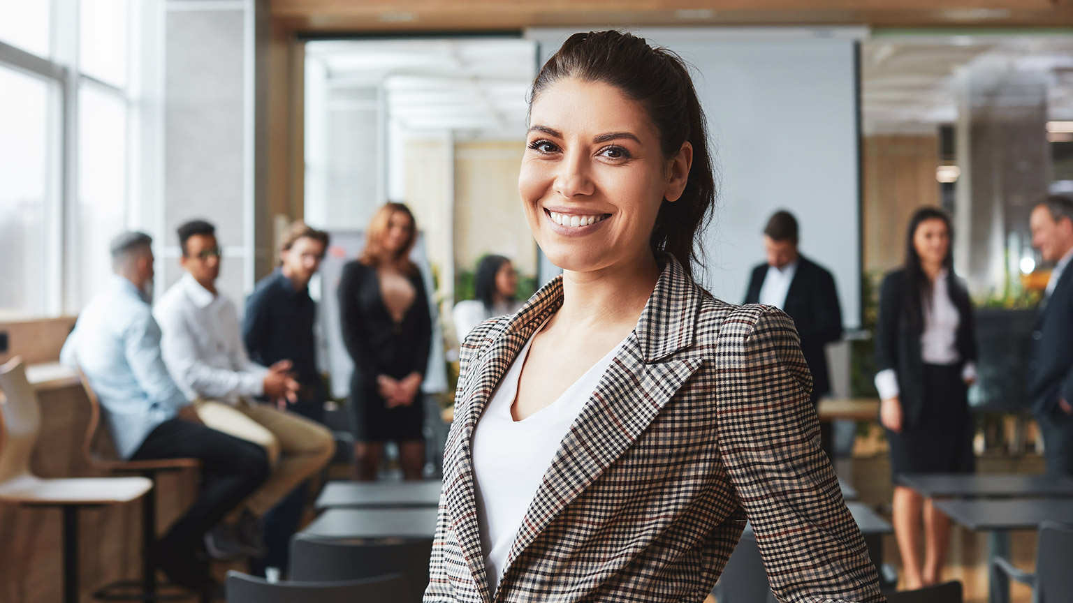 A business manager with colleagues in the background