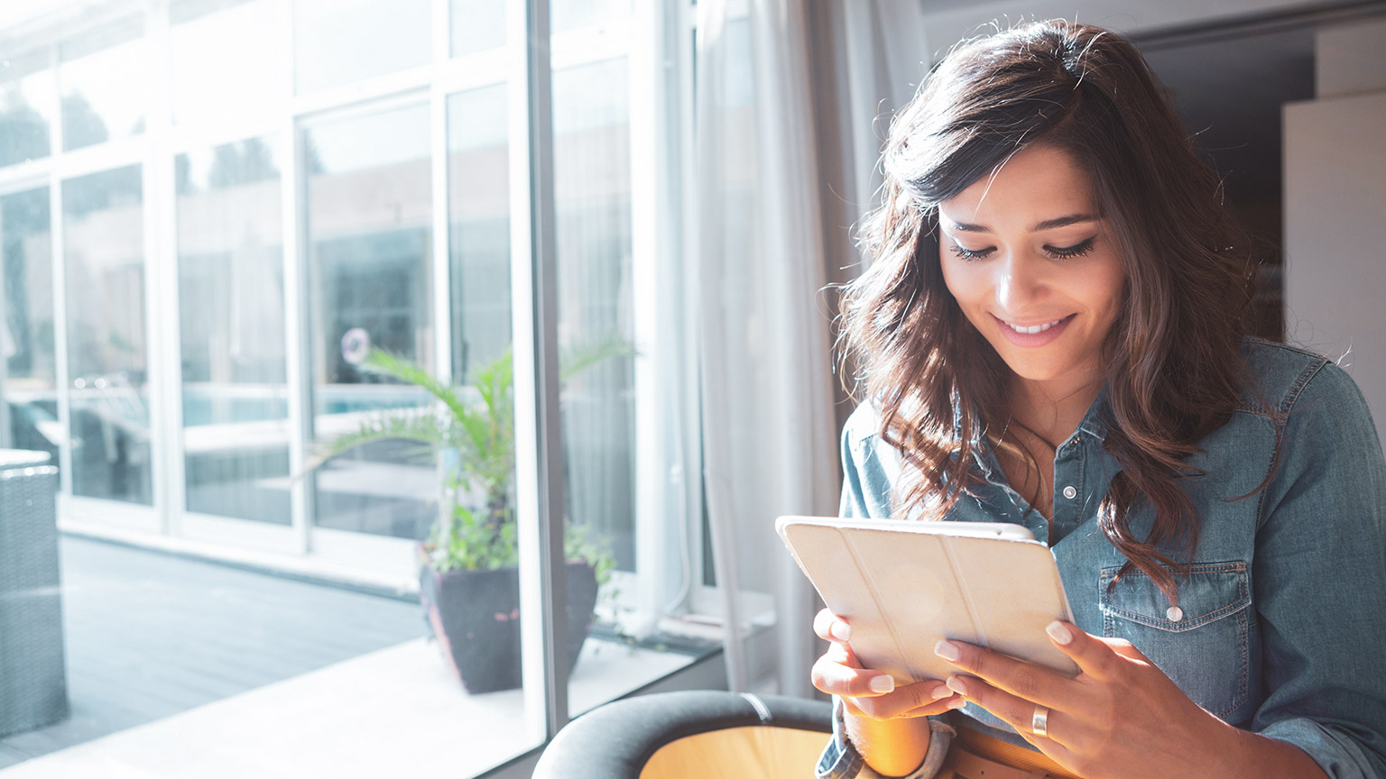 A person reading information on a tablet device