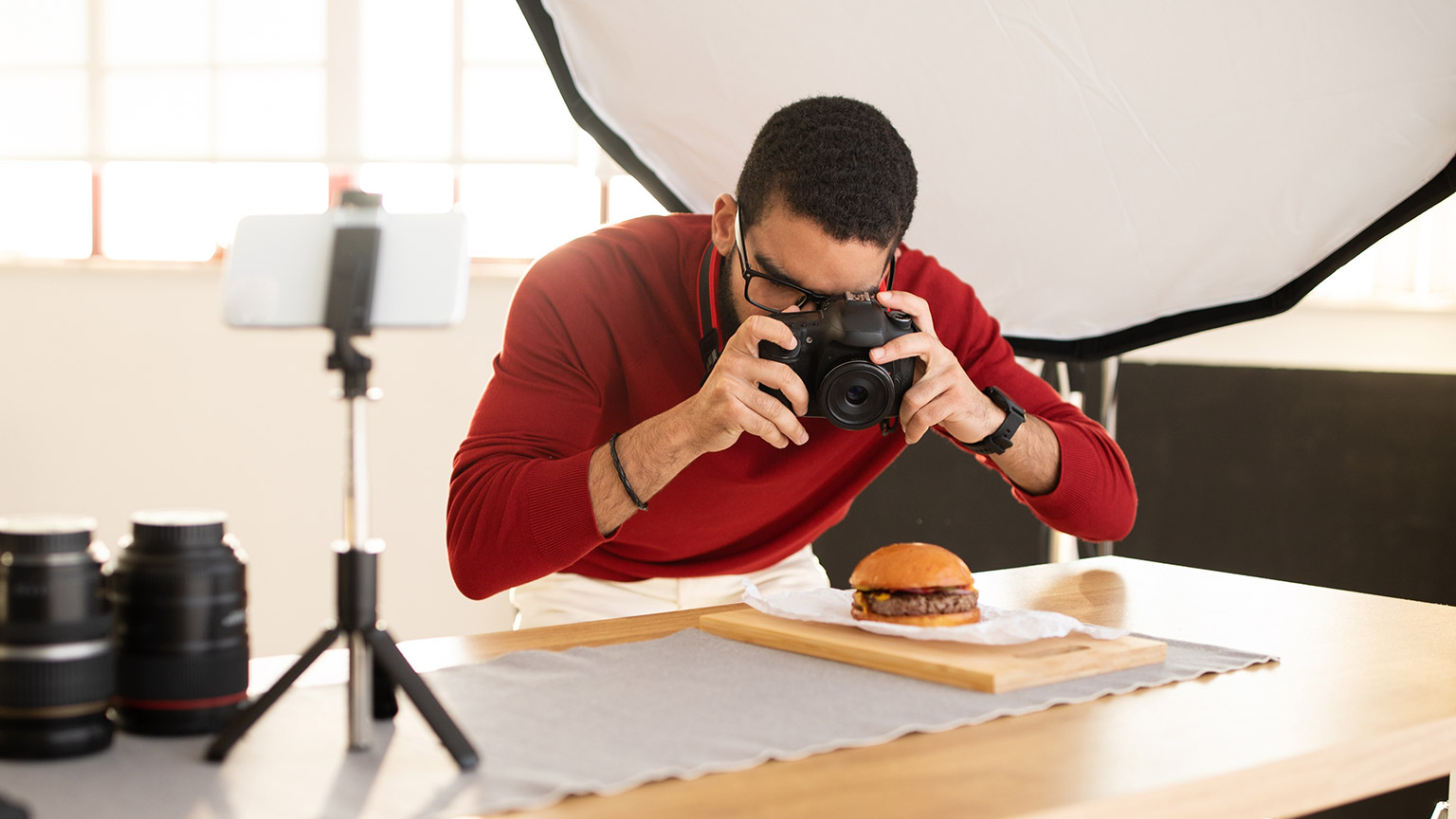 A person pretending to take a picture of food