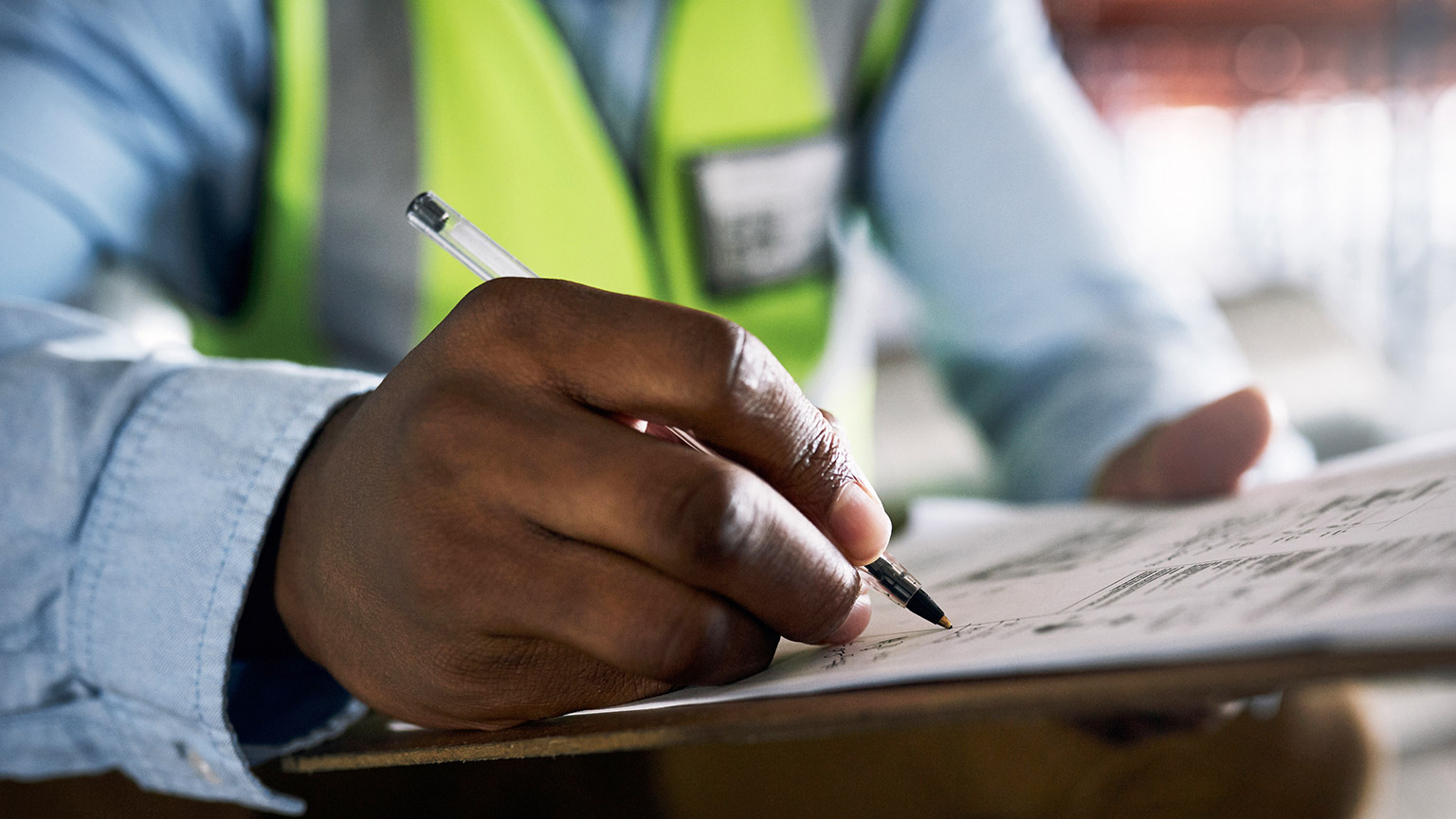 A close view of a person filling in paperwork