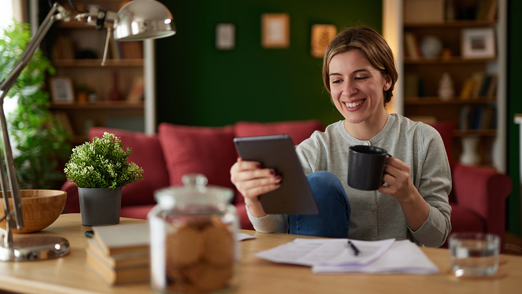 Women using digital tablet to check her finances at home office