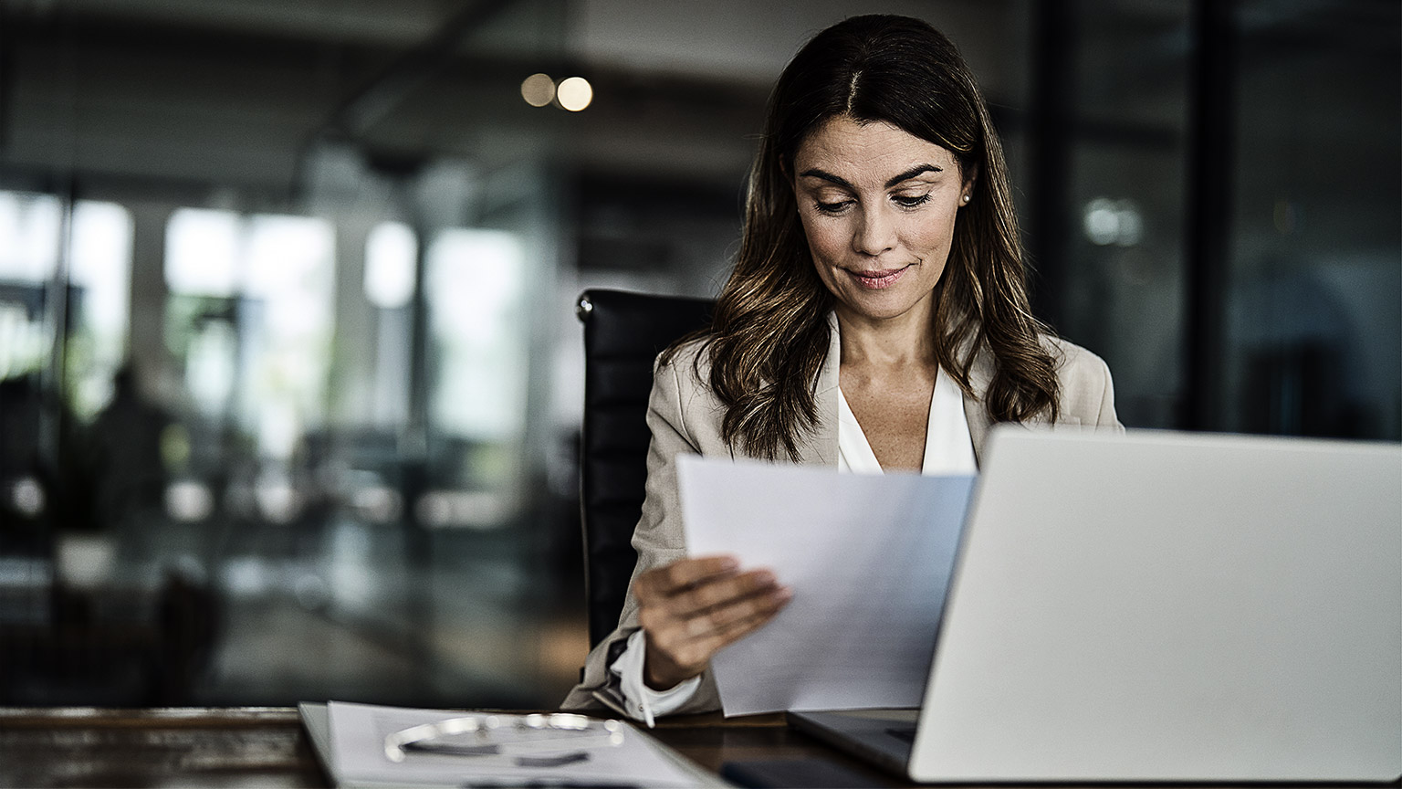 Mature professional female manager lawyer attorney holding paper