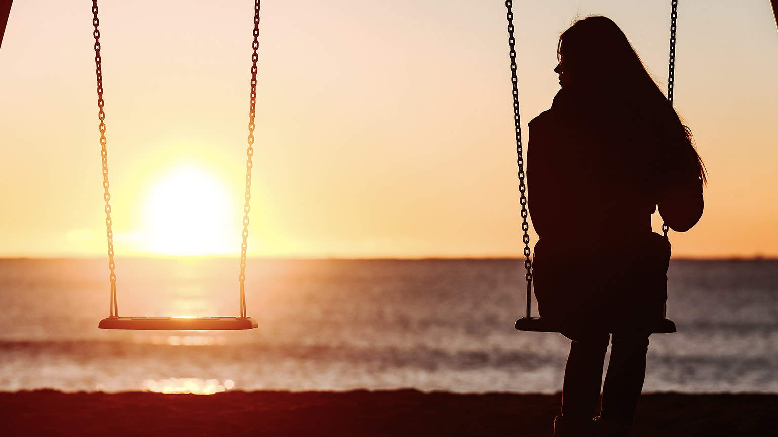 swinging infront of a beach