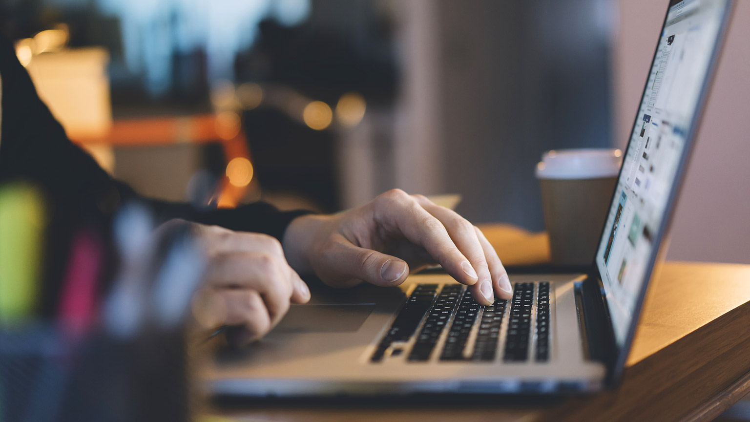 A close view of a person working on a laptop