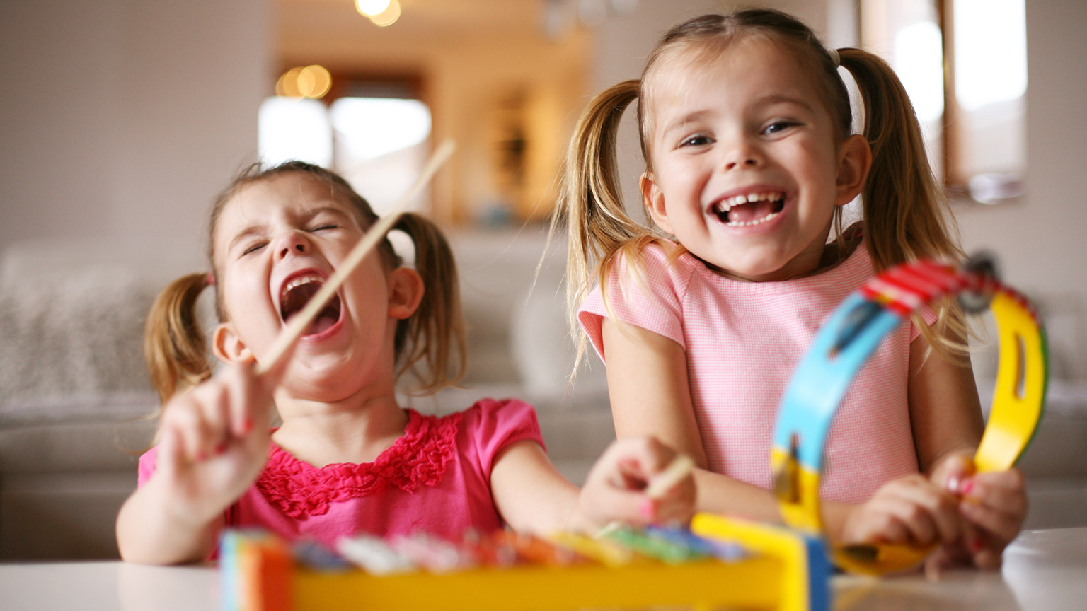 2 kids singing and playing instruments