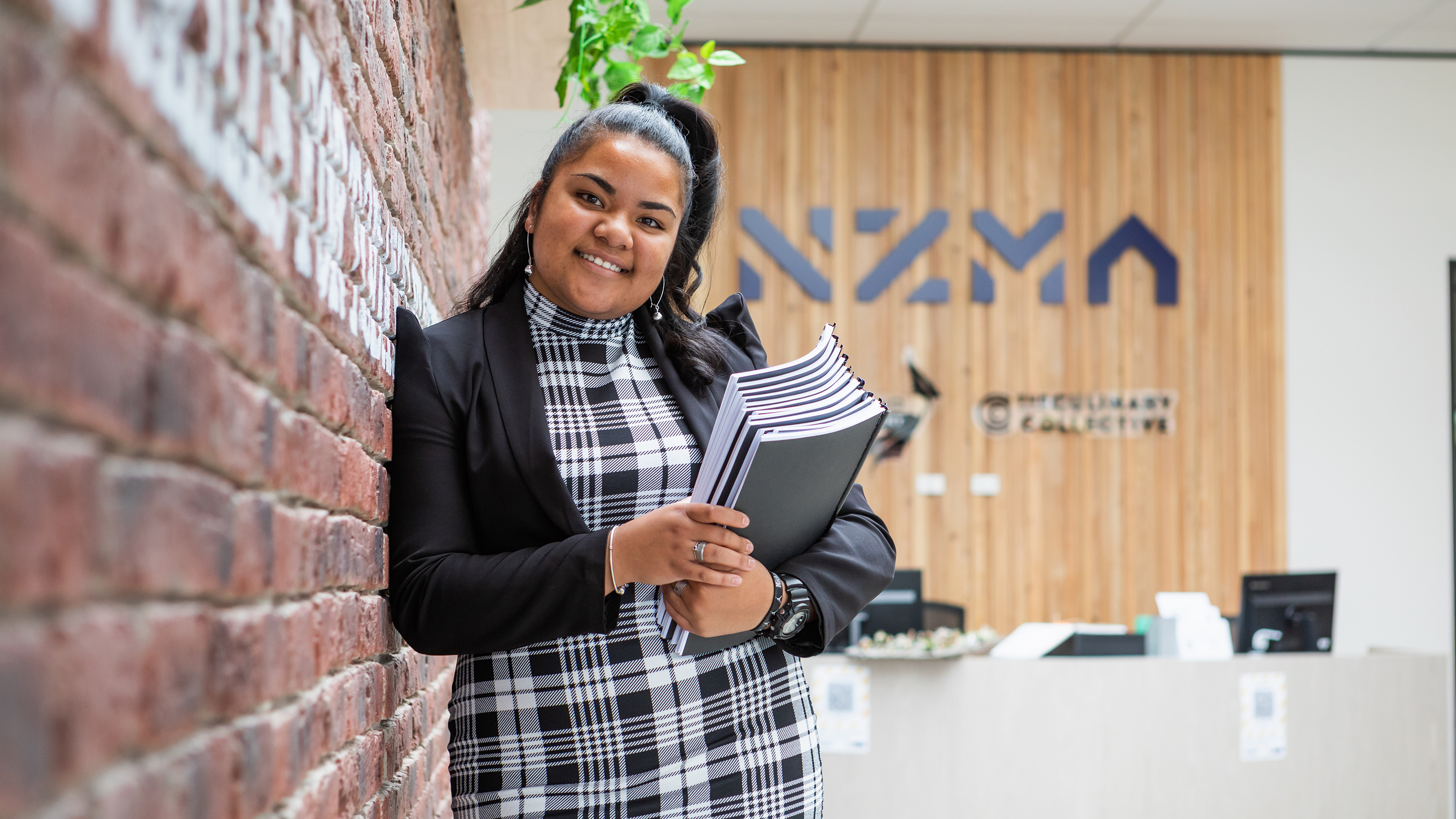 NZMA staff member smiling at the camera