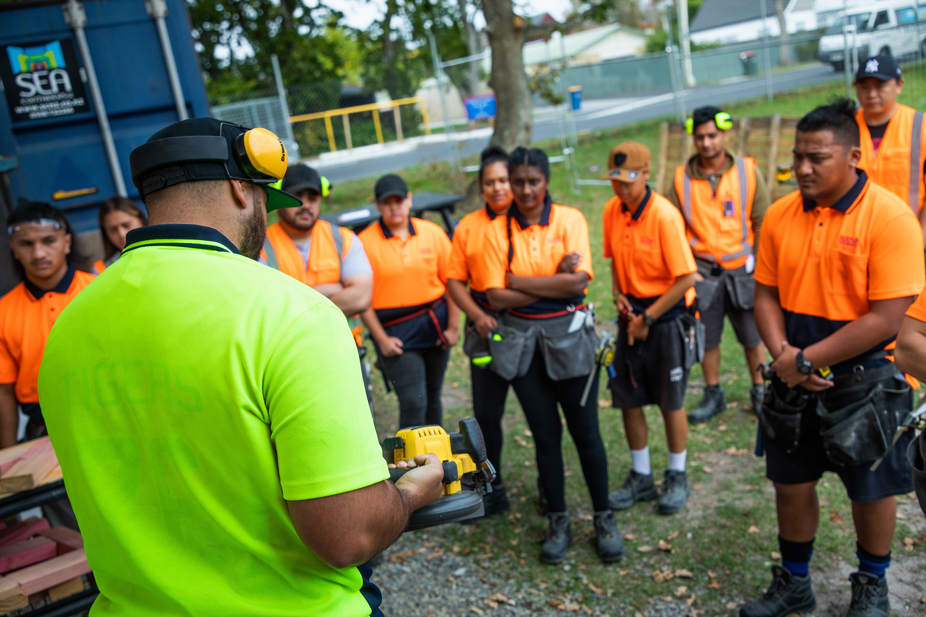 A staff member demonstrating a skill to students