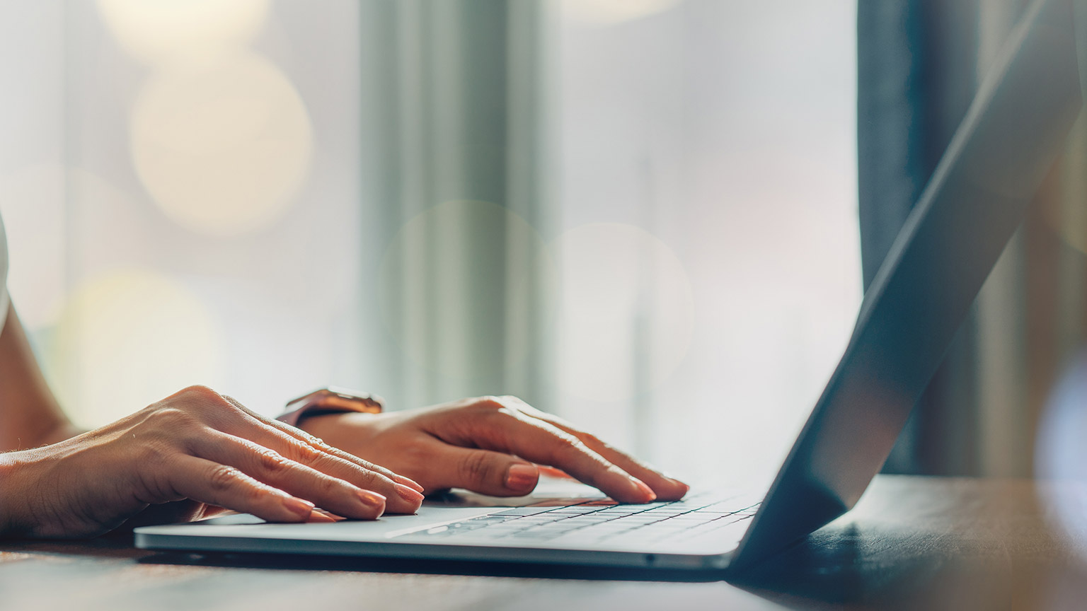 A close view of a person typing on a laptop keyboard