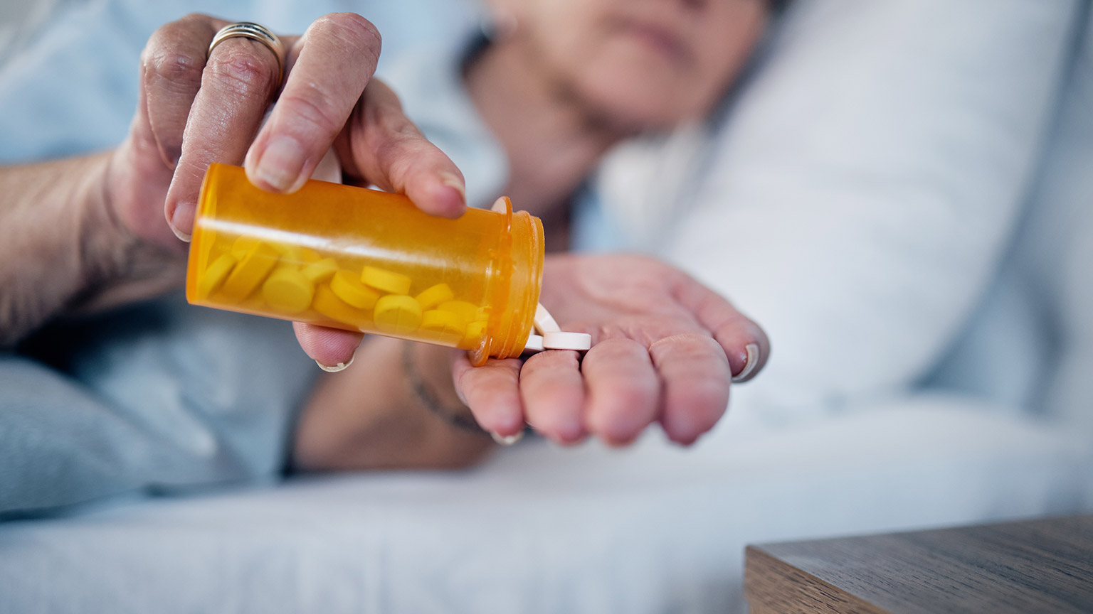 An elderly patient taking medication