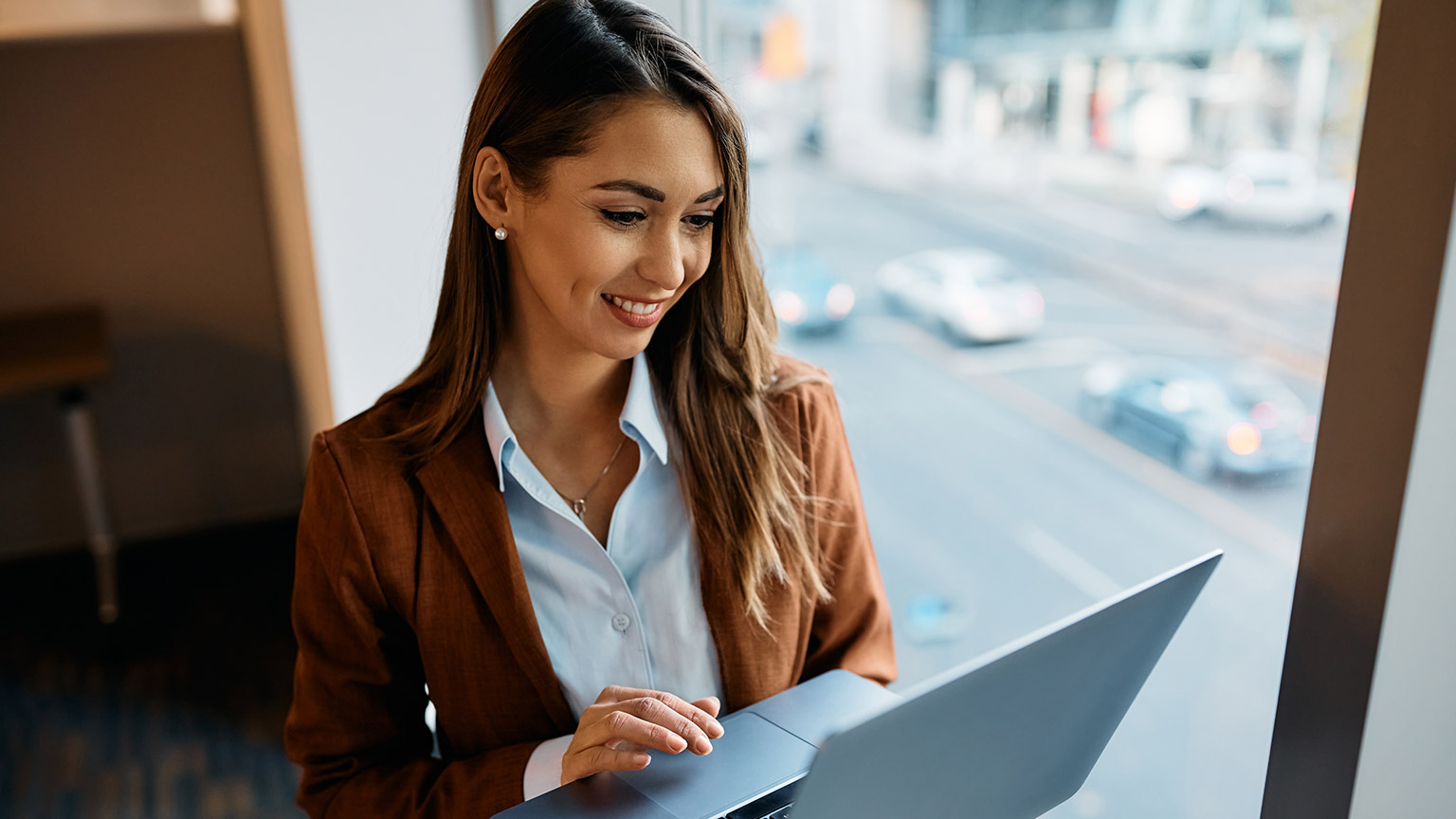 A business manager using productivity software on a laptop