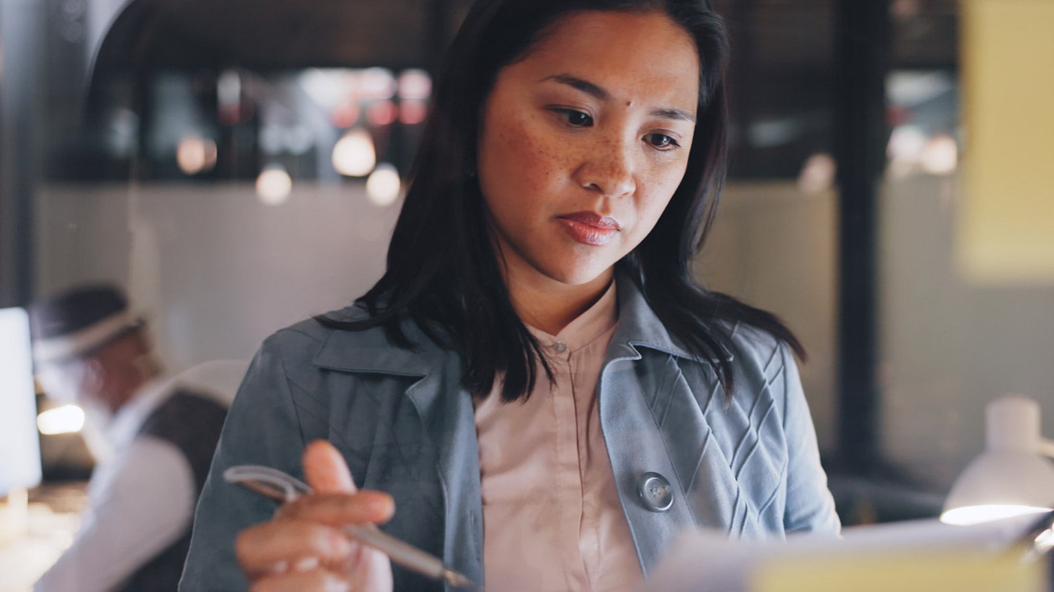 A manager reading a document in a modern office