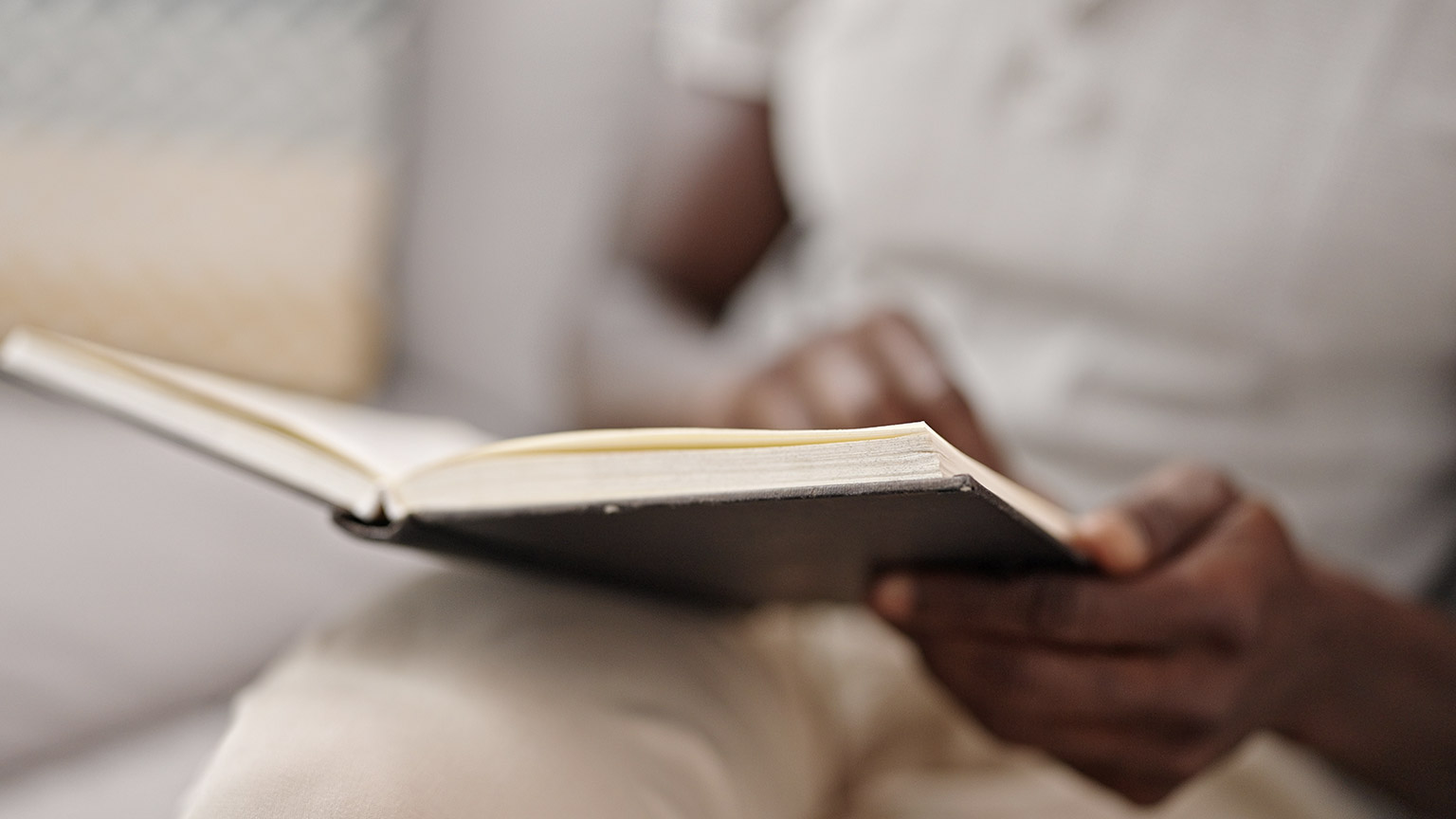 A close view of a person reading a book