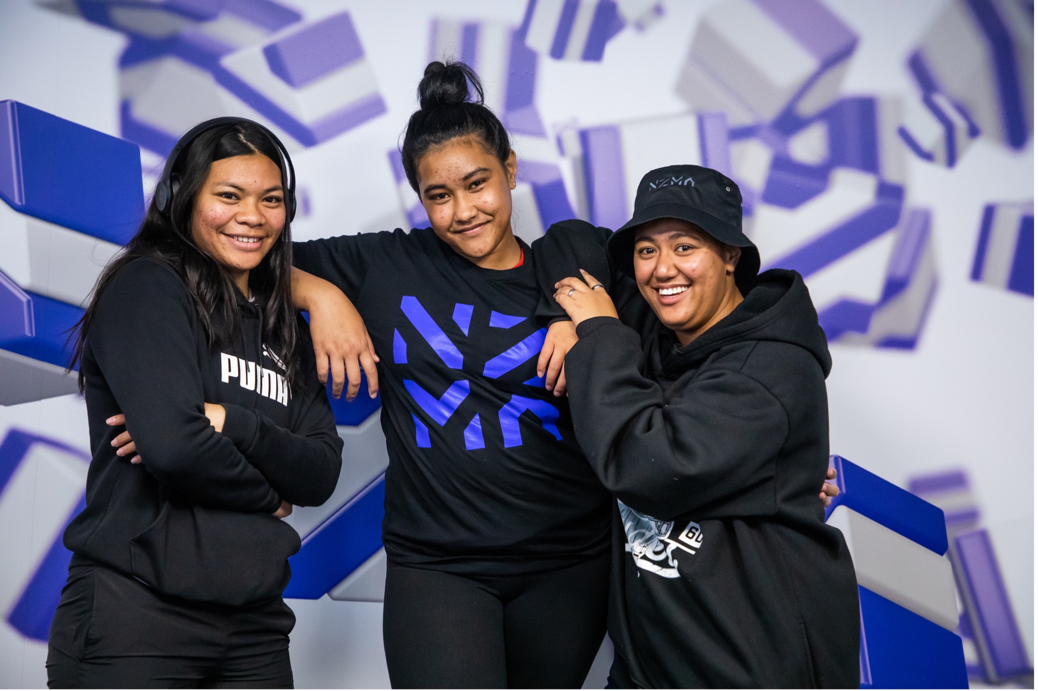 NZMA students standing in front of a blue and white background.