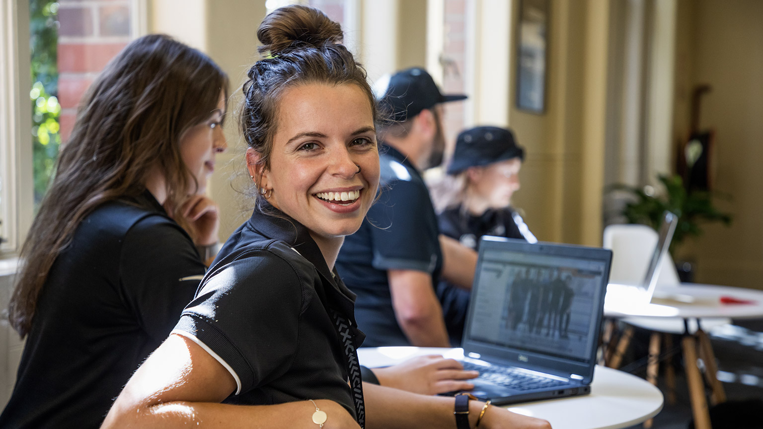 Smiling staff members in a classroom