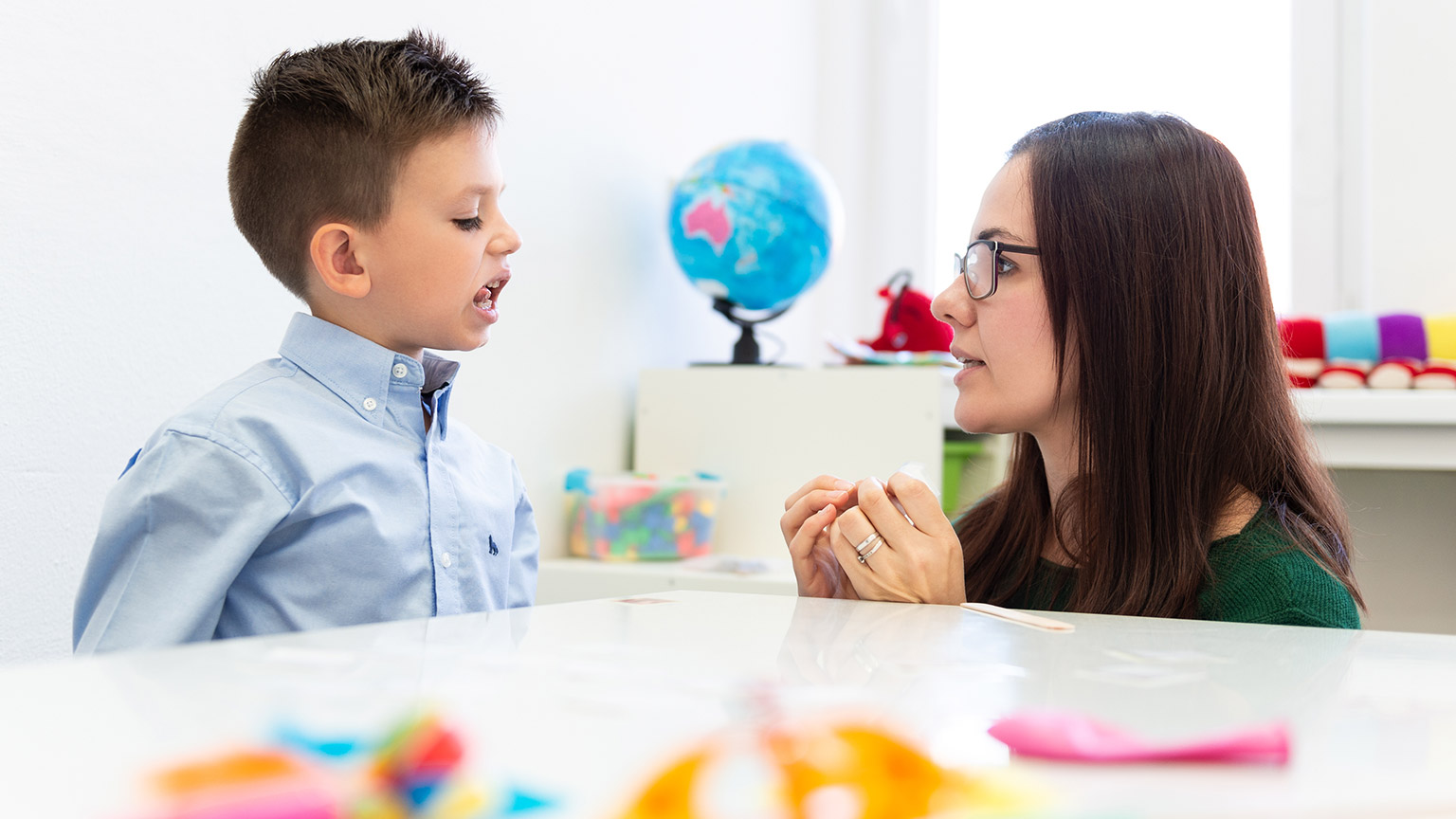 A therapist working with a young child