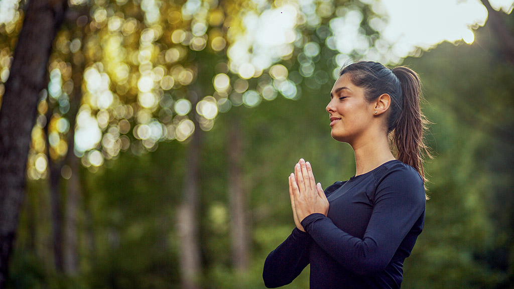 Young woman doing yoga in a park