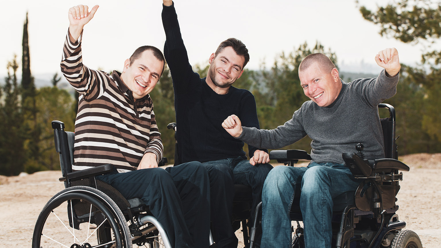 3 disabled adults enjoying an outdoor location