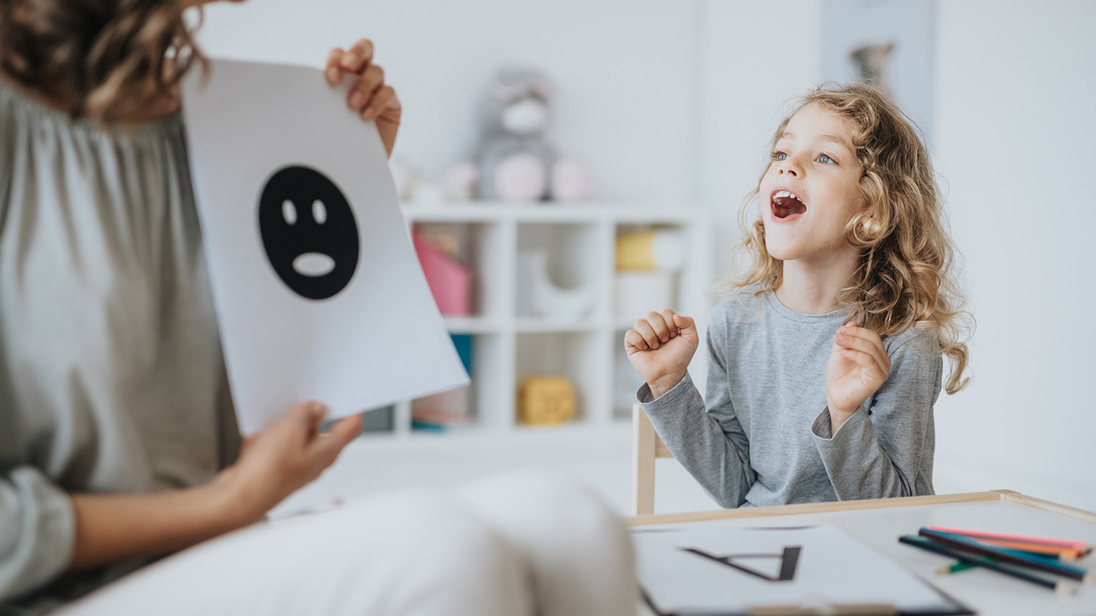 A therapist helping a child with learning difficulties