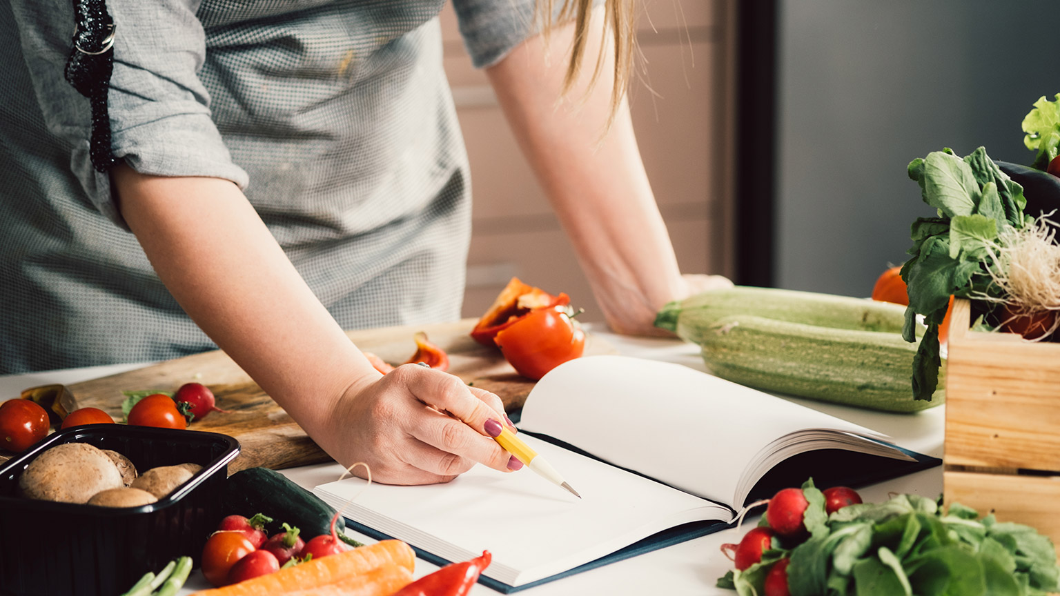 A person reading a recipe while cooking