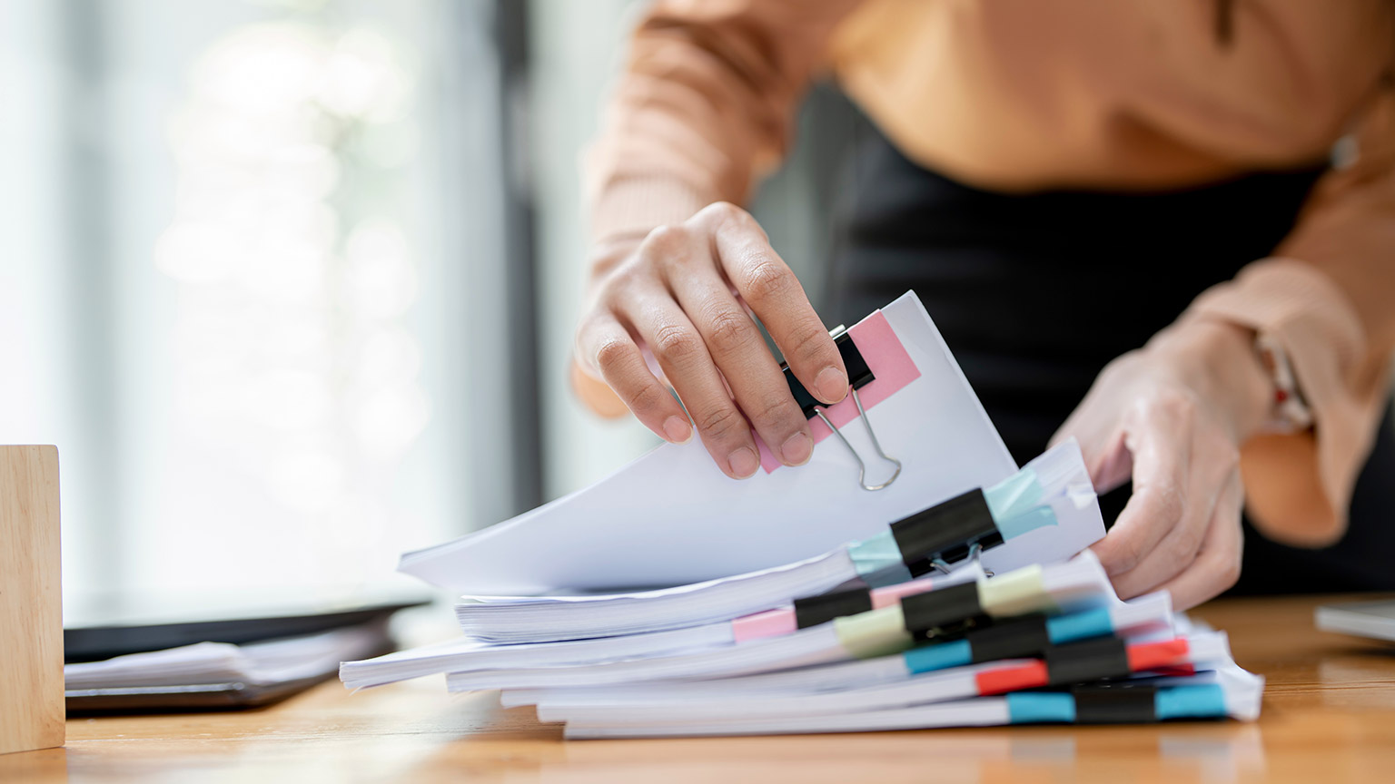 A close view of a person sorting through paperwork