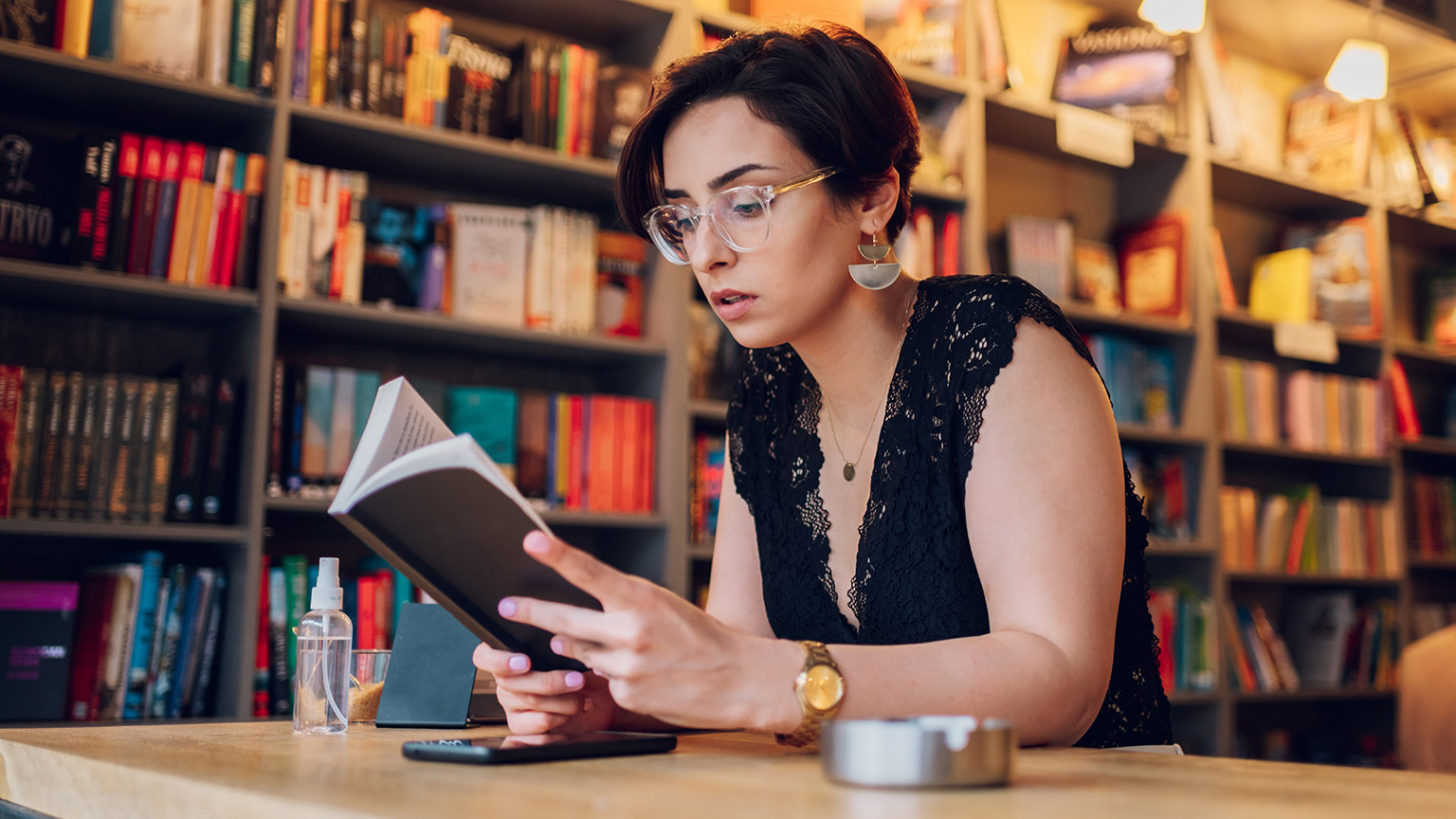 A person reading a book in a library