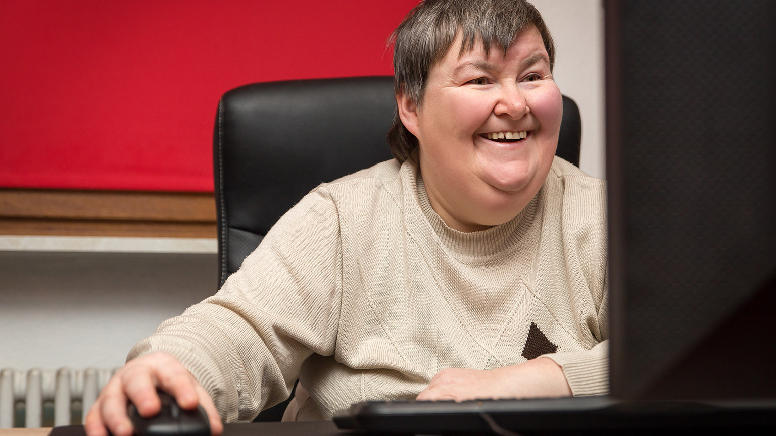 A person with a disability working on a computer