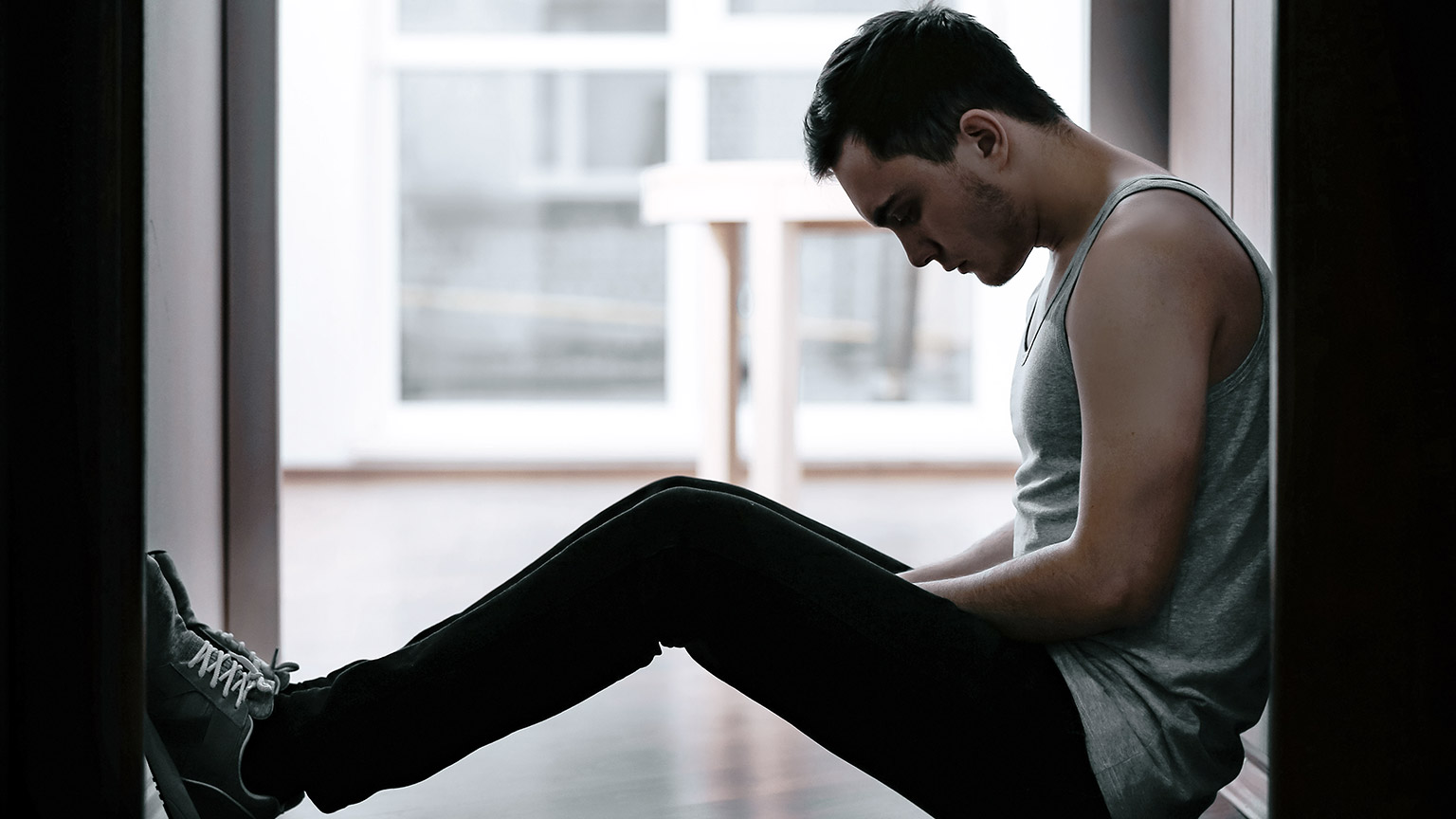 depressed man sitting on the floor