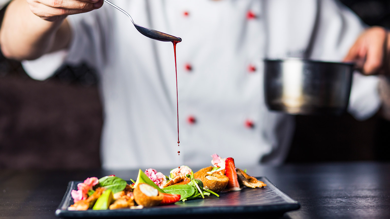 A chef plating up a dish