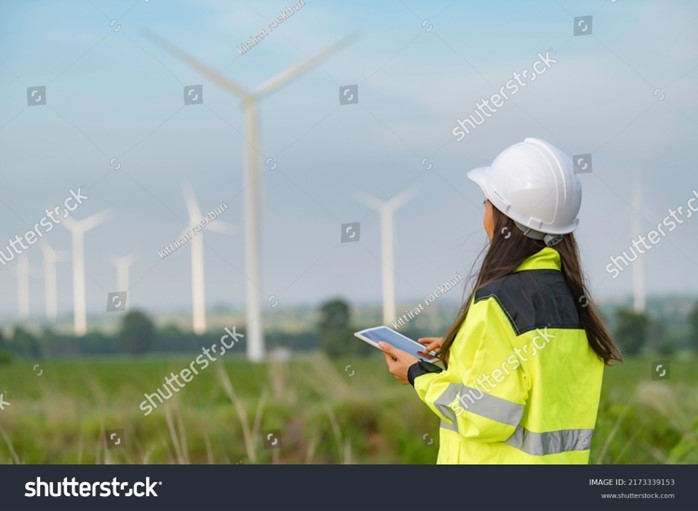 Woman collecting data about wind turbines